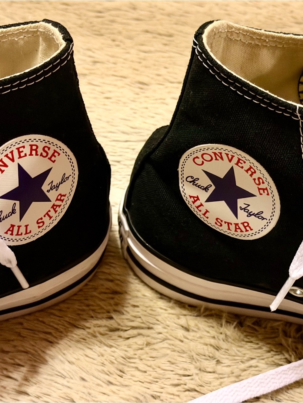 Converse women’s Chuck Taylor’s Black High Top Sneakers with Navy Star Logo